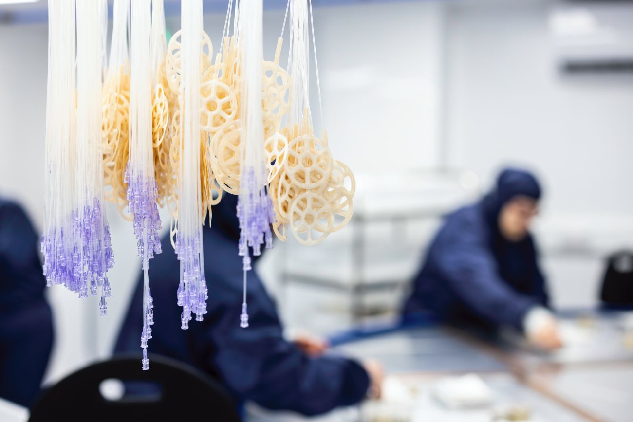 Cleanroom technicians preparing Negative Pressure Wound Therapy (NPWT) tubing assemblies with moulded suction ports and luer connectors at Meridian Medical, part of the company’s ISO 13485-certified wound care device manufacturing process.