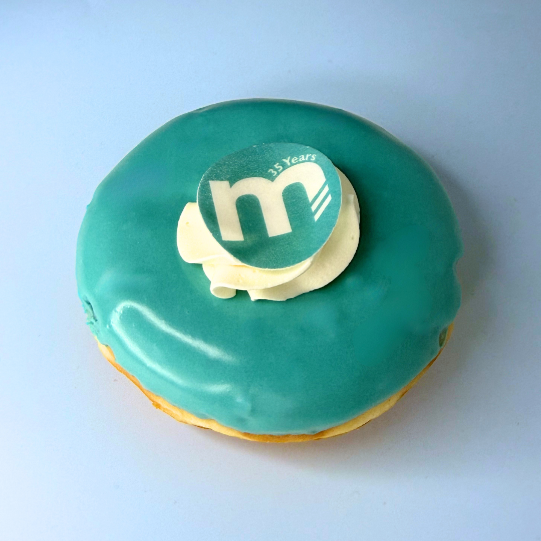 Personalised doughnuts created in Meridian Medicals branding colours to celebrate our 35th anniversary