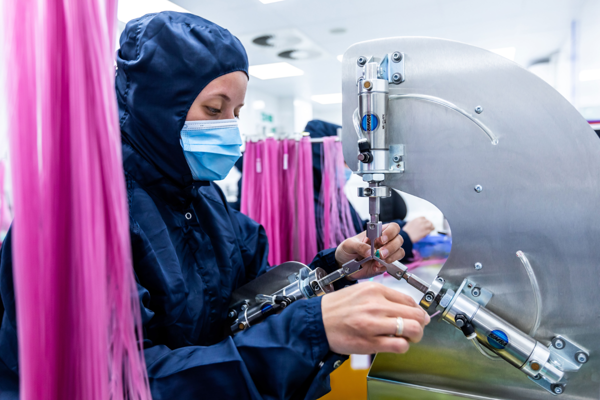 Cleanroom technician assembling sterile medical tubing components for single-use urology devices at Meridian Medical’s ISO Class 7 manufacturing facility
